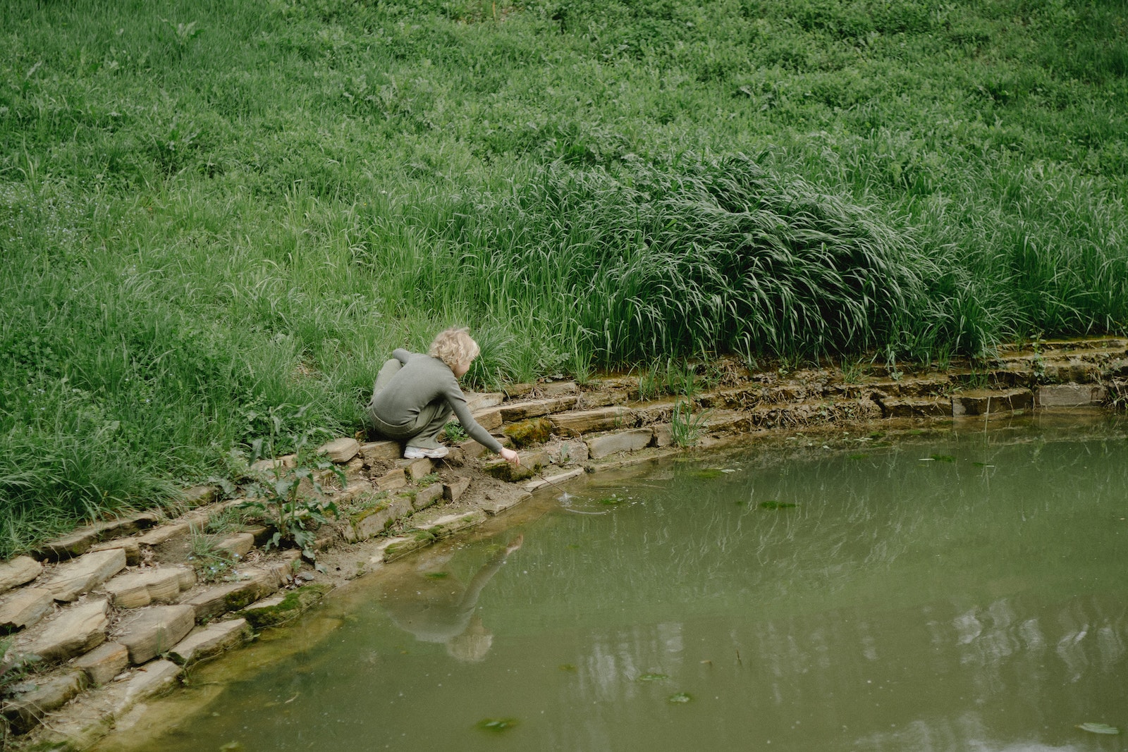 child near pond